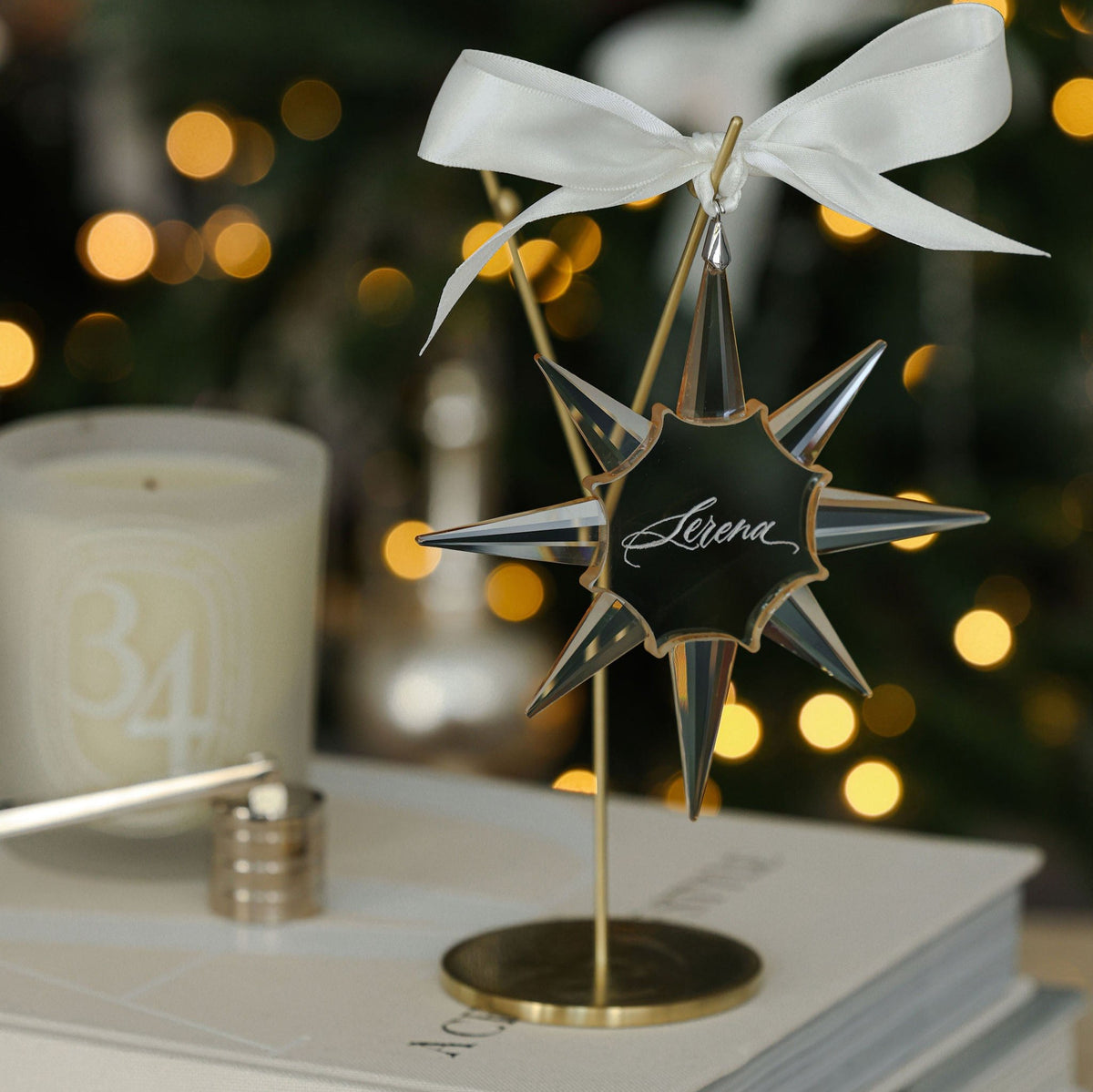 Personalised crystal star ornament engraved with a name on a gold stand