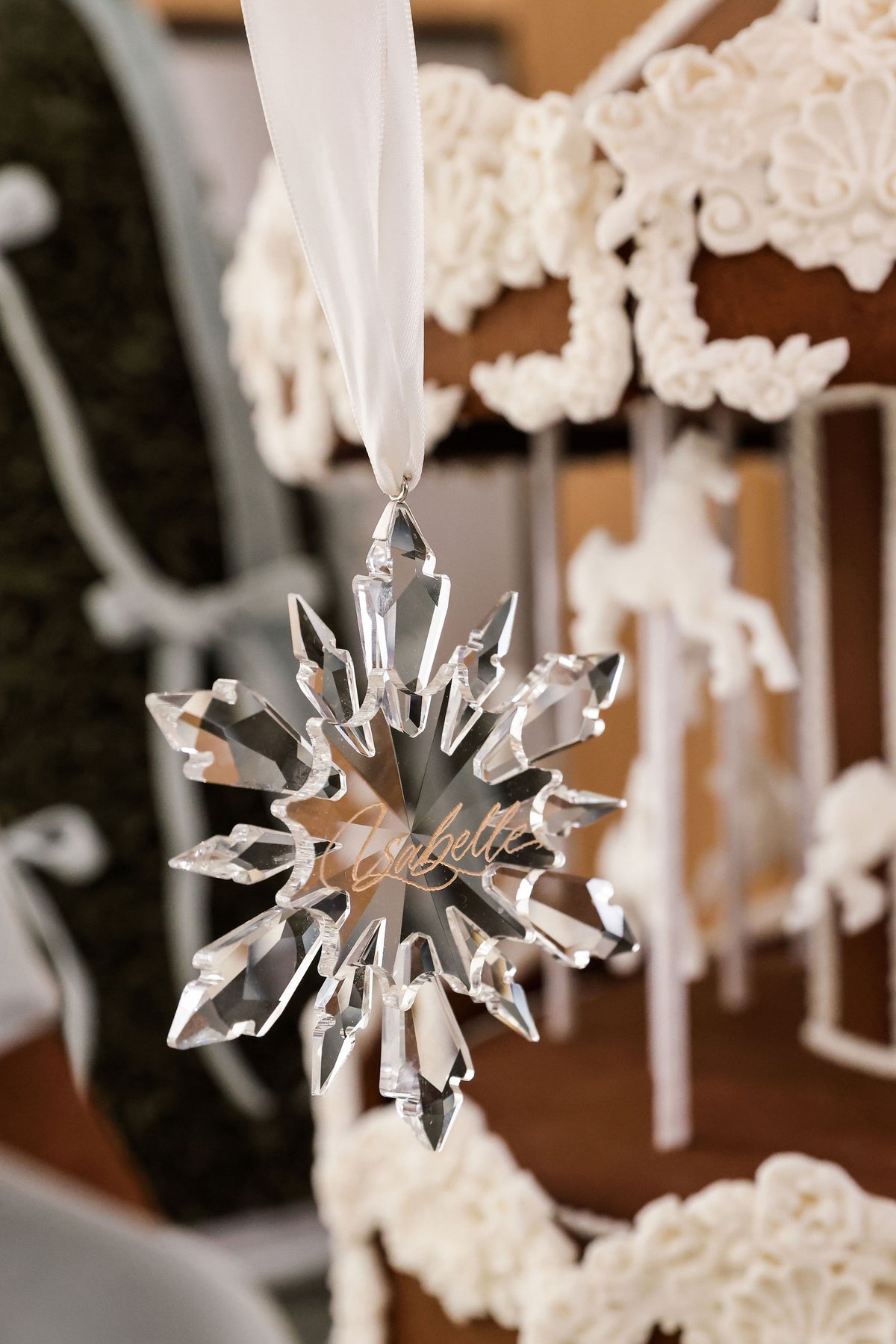 Crystal icicle snowflake Christmas ornament hanging by a gingerbread house