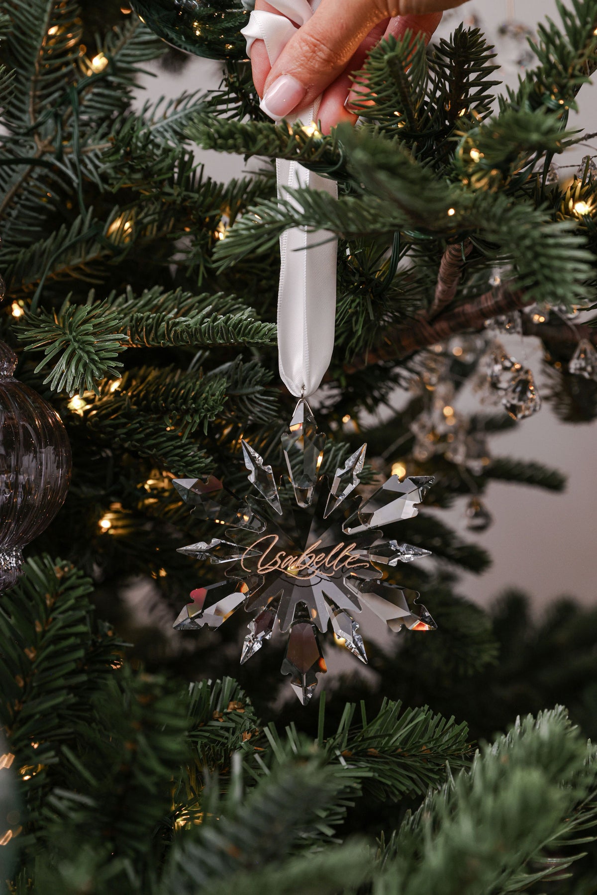 Engraved crystal icicle bauble hanging on a Christmas tree