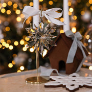 Personalised crystal icicle snowflake ornament on a gold stand with silver ribbon