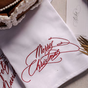 Merry Christmas embroidered napkin in ruby red calligraphy