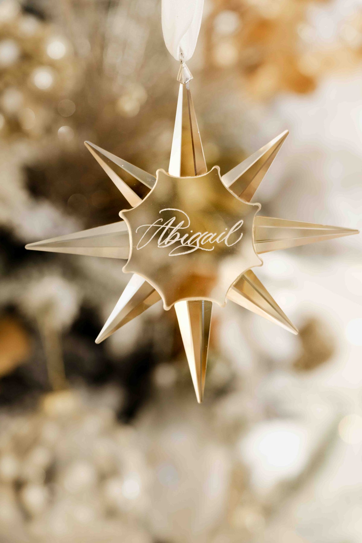 Close-up of calligraphy engraving on a golden crystal star bauble
