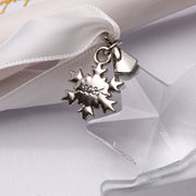 2024 snowflake year charm attached to a crystal ornament ribbon
