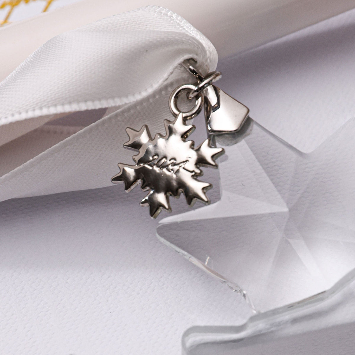 2024 snowflake year charm attached to a crystal ornament ribbon