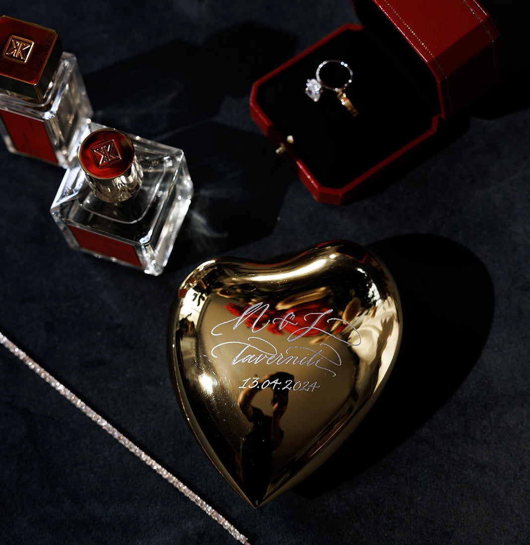 Engraved crystal heart keepsake with an engagement ring and perfume