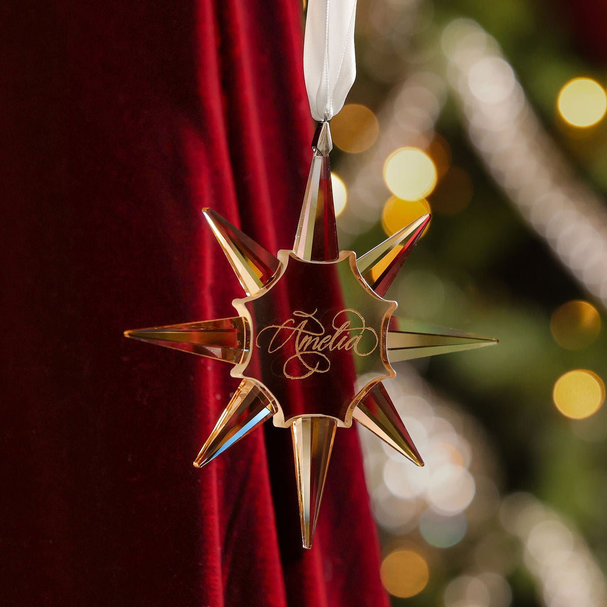 Gold crystal star ornament engraved in flourished opulent calligraphy