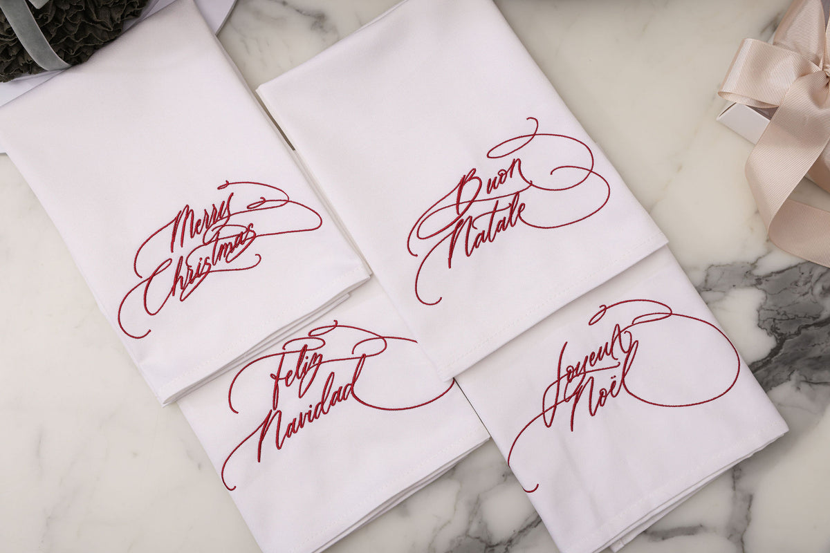 Set of four embroidered Christmas napkins in red calligraphy in four languages