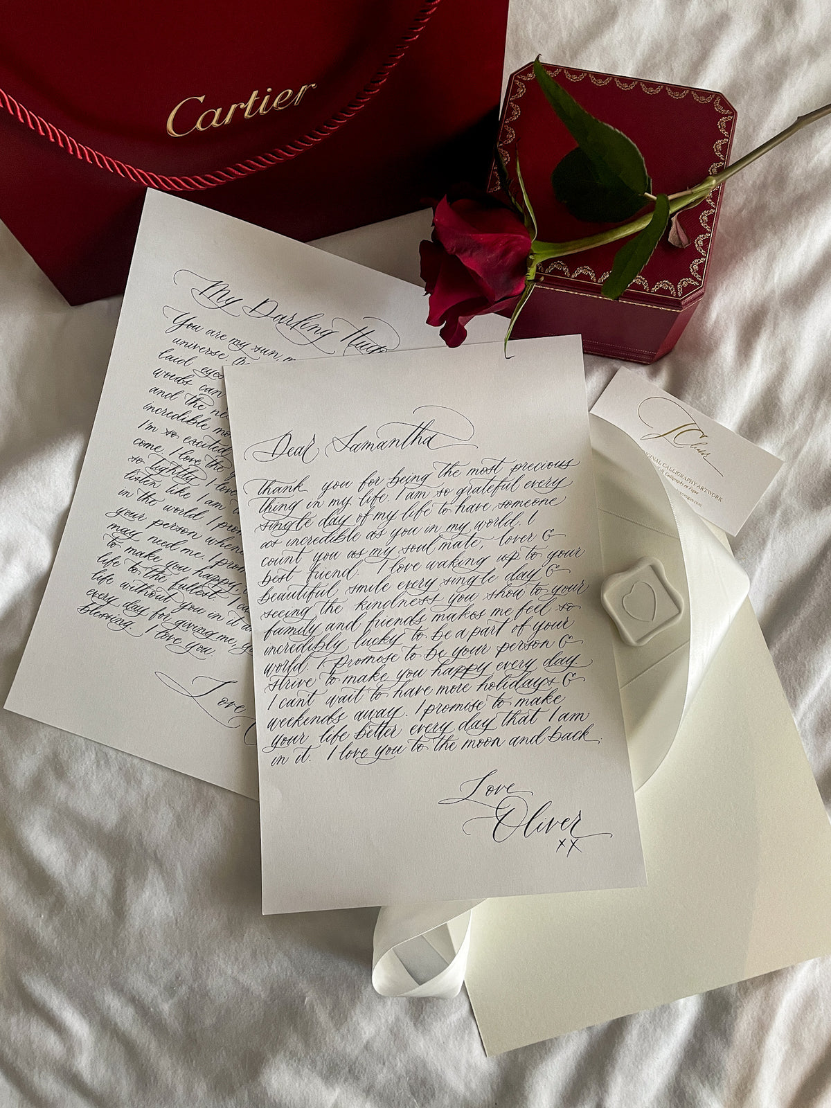 Handwritten calligraphy love letter with a Cartier box and red rose