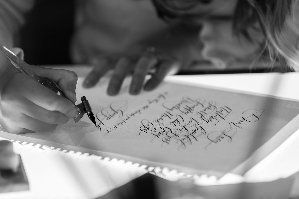Jo Eleanor writing a love letter in pointed pen calligraphy